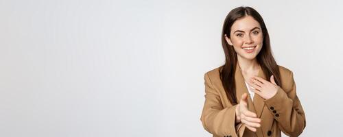 Portrait of smiling businesswoman extend hand for handshake, greeting business partner, saleswoman welcome client, white background photo
