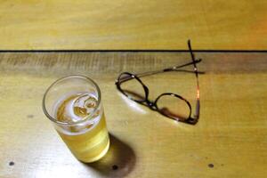 Take off your glasses and put them next to your glass after completing your daily tasks. Drinking is a way to relax and relieve stress. photo