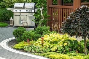 Lush Garden Landscape Featuring Grill Setup in a Backyard photo