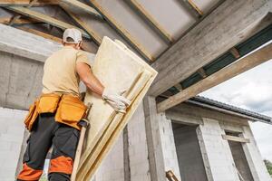 Construction Worker Installing Insulation in Residential Building Under Renovation photo