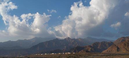 the mountains are covered with clouds in the desert photo