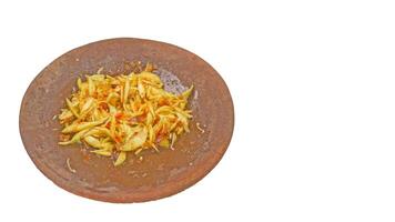 Sambal Mangga or Chili Sauce mixed with sliced young manggo fruit serve on traditional mortar and pestle isolated background. photo