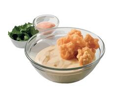 A bowl of dip with some fried chicken and some sauce vector