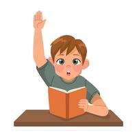 A boy is sitting at a table with his hand raised up vector