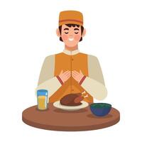 A man in an orange outfit is sitting at a table with a plate of food vector