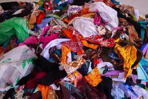 Flaps rag pieces of colorful fabrics which have been left from the sewing. photo