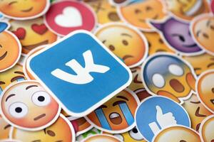 KYIV, UKRAINE - APRIL 20, 2024 VK logo and large set of stickers with Emoji yellow faces. Emoji is a pictogram or smiley embedded in text and used in electronic messages photo
