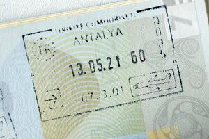 KYIV, UKRAINE - APRIL 20, 2024 Page of foreign passport with visas, Turkiye border stamps, permits to enter countries, concept of traveling around the world, travelers document photo