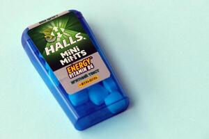 KYIV, UKRAINE - APRIL 20, 2024 Halls mini mints mint twist energy vitamin b6 small blue case with hard mints inside on blue background photo