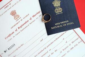 Indian Certificate of registration of marriage blank document and wedding ring with passport on table photo