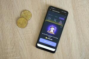 KYIV, UKRAINE - APRIL 20, 2024 Hamster Kombat telegram bot on smartphone screen. Hamster Kombat is a viral Telegram crypto game for earn HMSTR tokens by managing virtual crypto exchange photo
