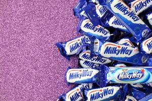 KYIV, UKRAINE - APRIL 20, 2024 Milky Way or MilkyWay small chocolate bars. Milky Way bars is worldwide famous product photo
