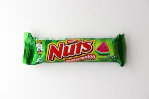 KYIV, UKRAINE - APRIL 20, 2024 Nuts watermelon taste chocolate bar manufactured by Nestle company. Small chocolate with nuts and nougat in colorful wrapping photo