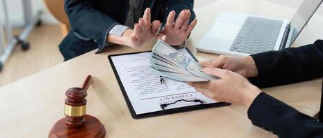 Lawyer Accepting Bribe Money for Corruption in Office Setting with Contract and Gavel on Desk photo