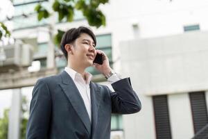 Confident Business Professional Talking on Smartphone Outdoors in Modern Urban Setting photo