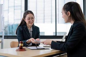 Professional Female Lawyers Discussing Legal Documents in Modern Office Setting photo
