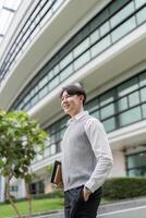 Confident Business Professional Smiling Outdoors in Front of Modern Office Building photo