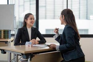 Professional Real Estate Agent Consulting with Client in Modern Office Setting photo