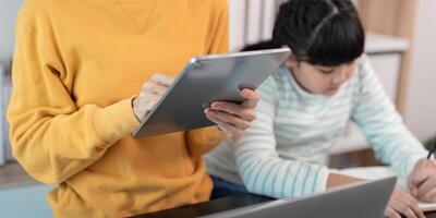 Mother and Daughter Using Digital Devices at Home for Learning and Entertainment photo