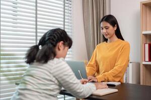 Mother and Child Working from Home Together in a Modern Home Office Setting with Natural Light photo