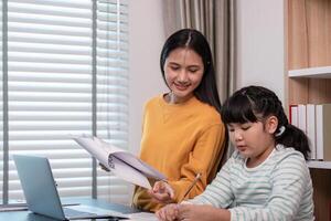 Mother and Child Working from Home Together in a Modern Home Office Setting with Laptop and Documents photo
