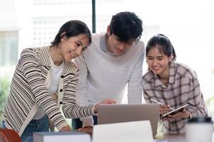 Group of Student Collaboration on a Project with a Laptop in a Modern Classroom Setting photo