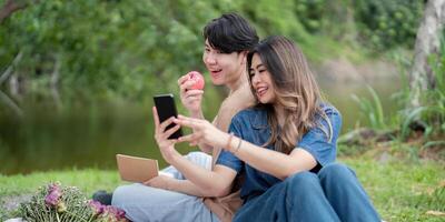 Happy Couple Enjoying a Relaxing Picnic by the Lake in a Beautiful Natural Setting photo
