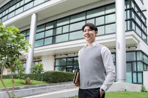 Young Professional Smiling Outside Modern Office Building Holding Notebook, Ready for Business Success photo