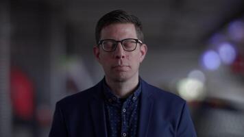The image is abstract, featuring a blurred and mysterious background with lights video