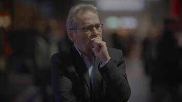 A man is deep in thought indoors, looking pensive and contemplative in a serene moment video