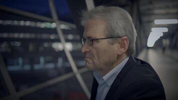 An introspective senior man in a modern city at night, showcasing wisdom and contemplation video