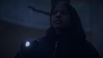 A person with a flashlight in a dark, eerie setting, creating a sense of mystery and suspense video