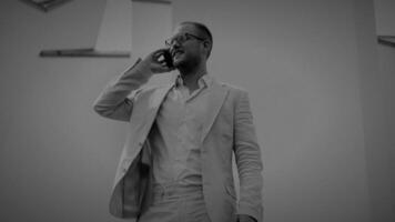 A businessman is engaged in a telephone conversation in a contemporary office setting video