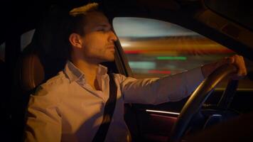 A Thoughtful Driver Navigating Through the Night in an Opulent Luxury Car on the Road video