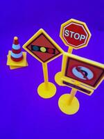 Toy traffic sign on a blue background photo