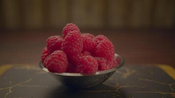 Fresh raspberries on a rustic background are full of antioxidants and vibrant colors video