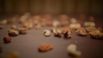 CloseUp of Assorted Nuts and Granola on Rustic Wooden Surface with Vintage Vibes video
