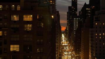 A city at night with glowing windows and street lights illuminating the urban landscape video