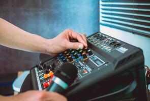 Sound engineer hands adjusting control sound mixer in recording, broadcasting studio,Sound mixer. Professional audio mixing console, buttons, faders and sliders. sound check. photo