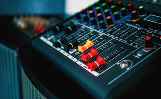 Close-up of sound recording equipment knobs.Mixer control. Music engineer. Backstage controls on an audio mixer, Sound mixer. Professional audio mixing console, buttons, faders and sliders. photo