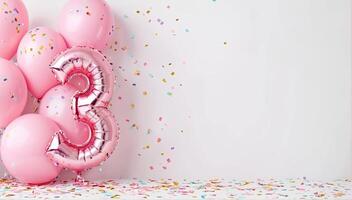 A festive celebration of the third birthday with balloons and confetti in pink pastel tones, an inflatable balloon with the number 3 on a white background. Banner with copy space. photo
