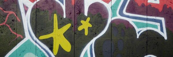 Colorful background of graffiti painting artwork with bright aerosol outlines on wall. Old school street art piece made with aerosol spray paint cans. Contemporary youth culture photo