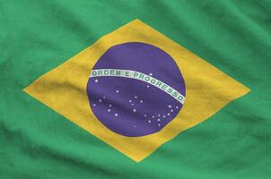 Brazil flag depicted on folded wavy fabric of old cloth photo