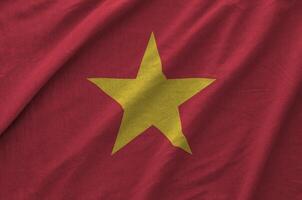 Vietnam flag depicted on folded wavy fabric of old cloth photo