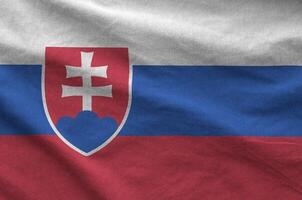 Slovakia flag depicted on folded wavy fabric of old cloth photo