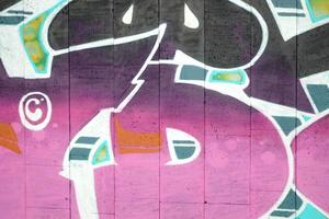 Colorful background of graffiti painting artwork with bright aerosol outlines on wall. Old school street art piece made with aerosol spray paint cans. Contemporary youth culture photo