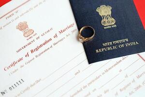 Indian Certificate of registration of marriage blank document and wedding ring with passport on table photo
