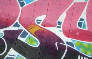 Colorful background of graffiti painting artwork with bright aerosol outlines on wall. Old school street art piece made with aerosol spray paint cans. Contemporary youth culture photo