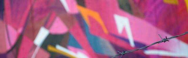 Colorful background of graffiti painting artwork with bright aerosol outlines on wall. Old school street art piece made with aerosol spray paint cans. Contemporary youth culture photo