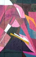 Colorful background of graffiti painting artwork with bright aerosol outlines on wall. Old school street art piece made with aerosol spray paint cans. Contemporary youth culture photo